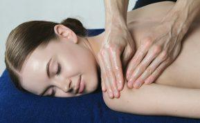 a woman getting a back massage at a spa